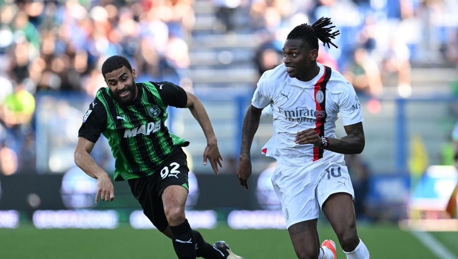 REGGIO NELL'EMILIA, ITALY - APRIL 14:  Rafael Leao of AC Milan competes for the ball with Gregoire Defrel of US Sassuolo during the Serie A TIM match between US Sassuolo and AC Milan at Mapei Stadium - Citta' del Tricolore on April 14, 2024 in Reggio nell'Emilia, Italy. (Photo by Claudio Villa/AC Milan via Getty Images)