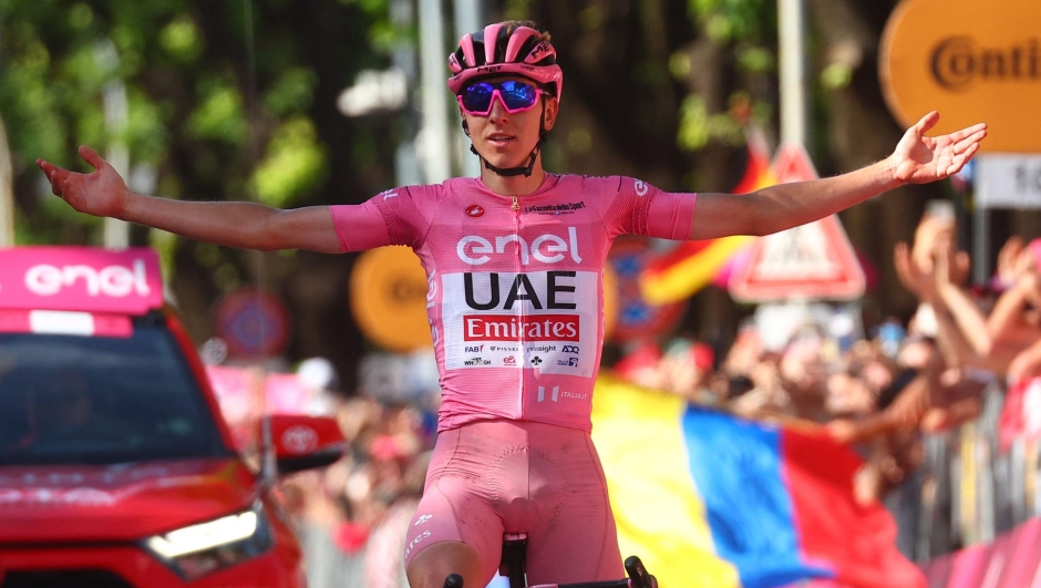 Team UAE's Slovenian rider Tadej Pogacar wearing the overall leader's pink jersey celebrates as he crosses the finish line to win the 20th stage of the 107th Giro d'Italia cycling race, 184km between Alpago and Bassano del Grappa on May 25, 2024. (Photo by Luca Bettini / AFP)