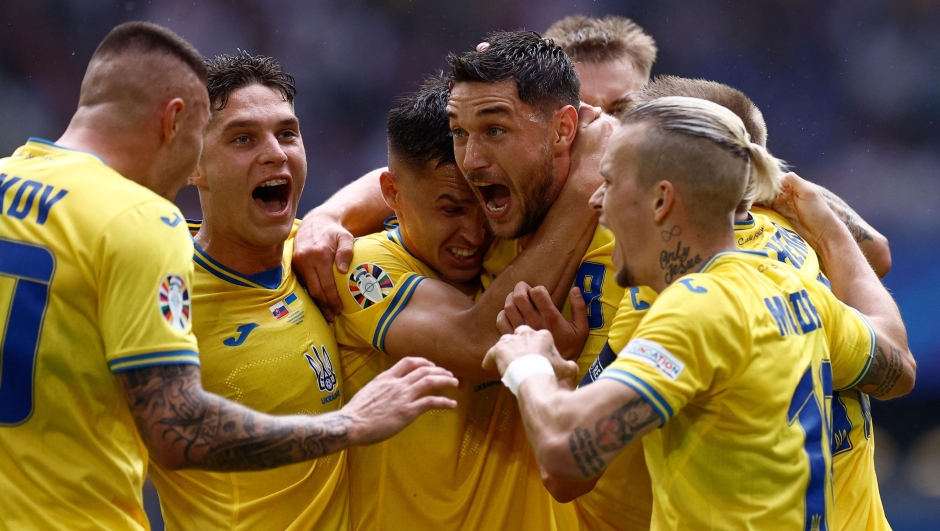 Ukraine's forward #09 Roman Yaremchuk (2nd R) celebrates scoring his team's second goal with his teammates during the UEFA Euro 2024 Group E football match between Slovakia and Ukraine at the Duesseldorf Arena in Duesseldorf on June 21, 2024. (Photo by KENZO TRIBOUILLARD / AFP)