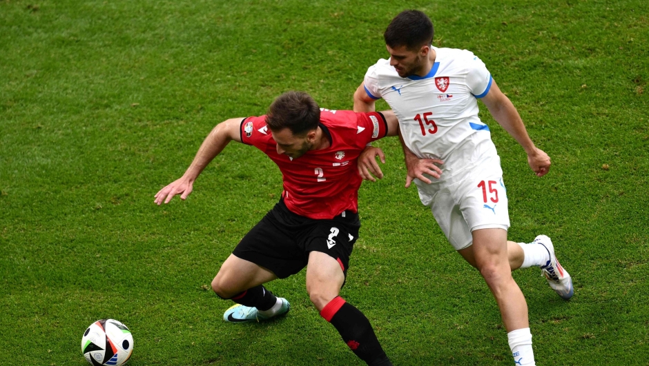 Czech Republic's defender #15 David Jurasek (R) fights for the ball with Georgia's defender #02 Otar Kakabadze during the UEFA Euro 2024 Group F football match between Georgia and the Czech Republic at the Volksparkstadion in Hamburg on June 22, 2024. (Photo by Christophe SIMON / AFP)