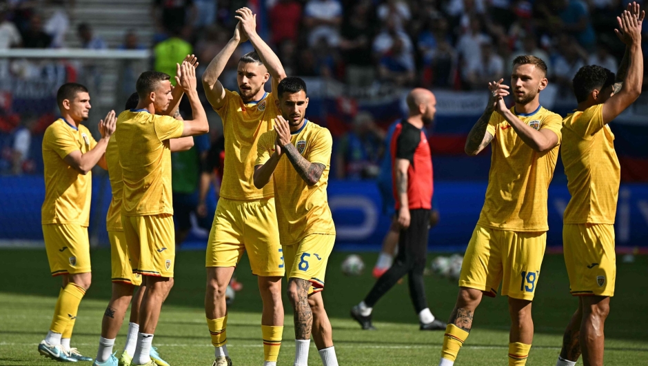 Romania's players applaud their fans as they warm up ahead of the UEFA Euro 2024 Group E football match between Slovakia and Romania at the Frankfurt Arena in Frankfurt am Main on June 26, 2024. (Photo by JAVIER SORIANO / AFP)