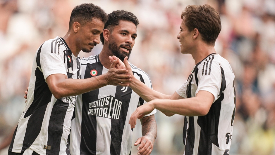 Juventus’ Danilo celebrates after scoring the 1-0 goal for his team with his team mates Juventus’ Douglas Luiz and Juventus’ Arkadiusz Milik during the pre season friendly soccer match between Juventus and Juvetus Next Gen at the Allianz Stadium in Torino, north west Italy - Tuesday, August 6, 2024. Sport - Soccer . (Photo by Marco Alpozzi/Lapresse)