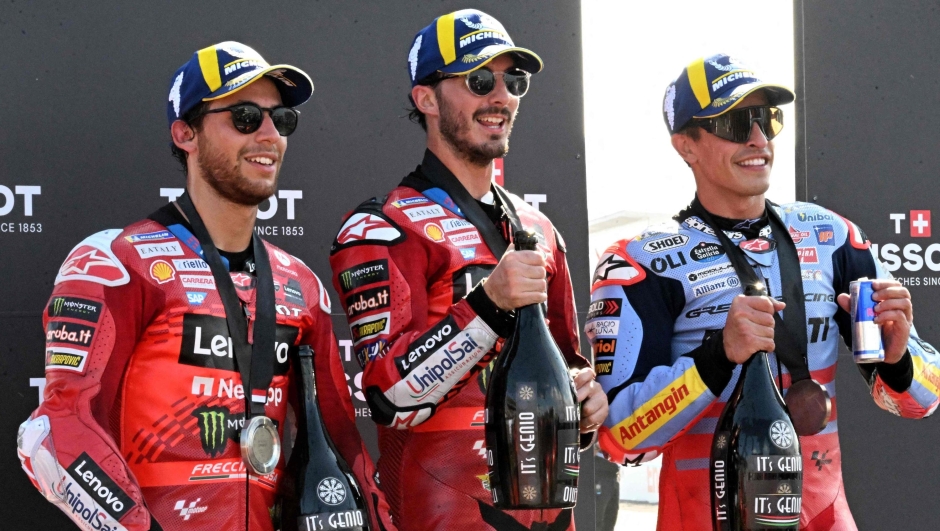 (L-R) Second-placed Ducati Lenovo Team's Italian rider Enea Bastianini, first-placed Ducati Lenovo Team's Italian rider Francesco Bagnaia, and third-placed Gresini Racing MotoGP's Spanish rider Marc Marquez, celebrate on the podium following the MotoGP sprint race of the Indonesian Grand Prix at the Mandalika International Circuit in Mandalika, West Nusa Tenggara on September 28, 2024. (Photo by SONNY TUMBELAKA / AFP)