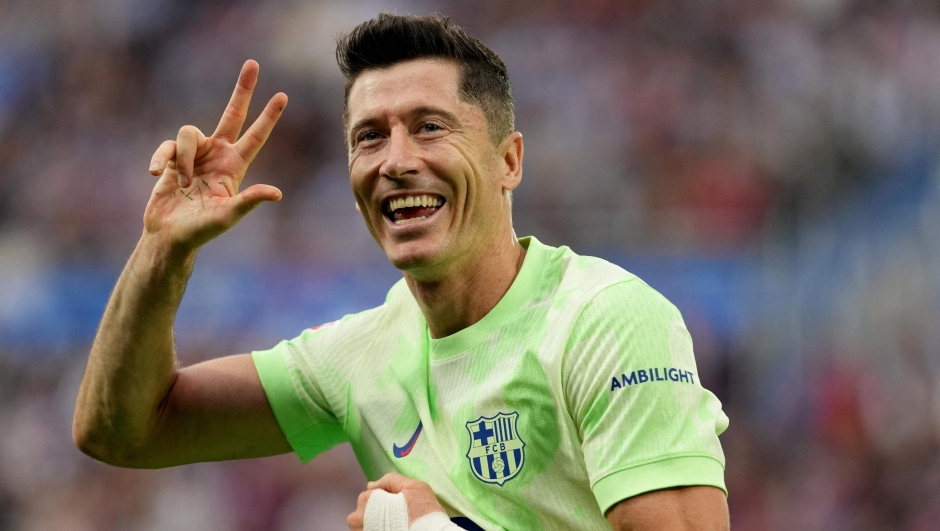 Barcelona's Polish forward #09 Robert Lewandowski celebrates after scoring a hat-trick during the Spanish league football match between Deportivo Alaves and FC Barcelona at the Mendizorroza stadium in Vitoria on October 6, 2024. (Photo by Cesar Manso / AFP)