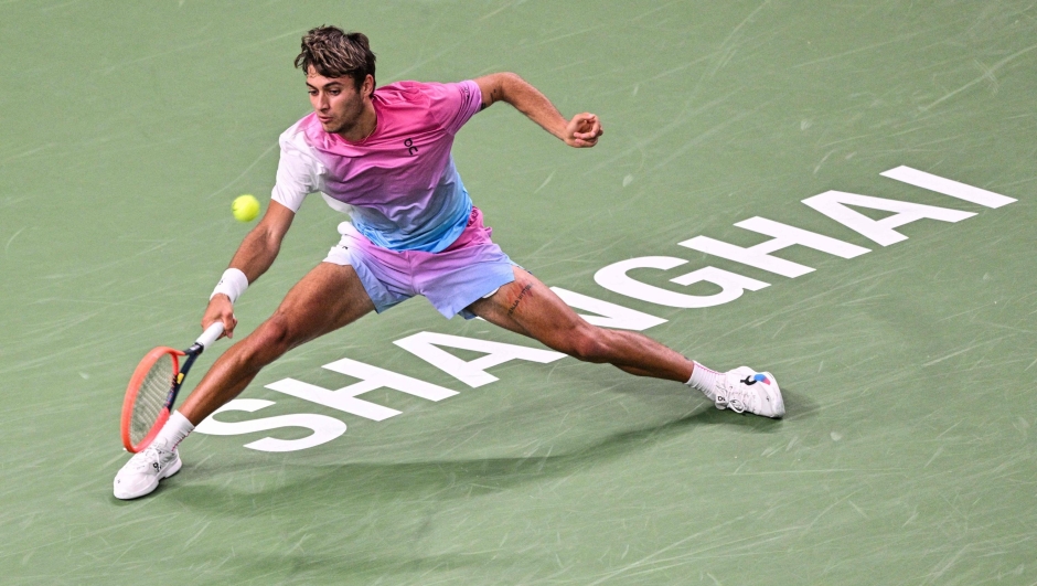 Italy's Flavio Cobolli hits a return to Switzerland'S Stan Wawrinka during their men's singles match at the Shanghai Masters tennis tournament in Shanghai on October 7, 2024. (Photo by Hector RETAMAL / AFP)