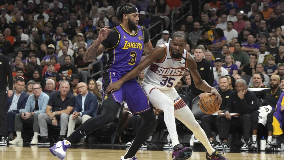 Phoenix Suns forward Kevin Durant (35) shields the ball from Los Angeles Lakers forward Anthony Davis (3) during the first half of an NBA basketball game, Monday, Oct. 28, 2024, in Phoenix. (AP Photo/Rick Scuteri)