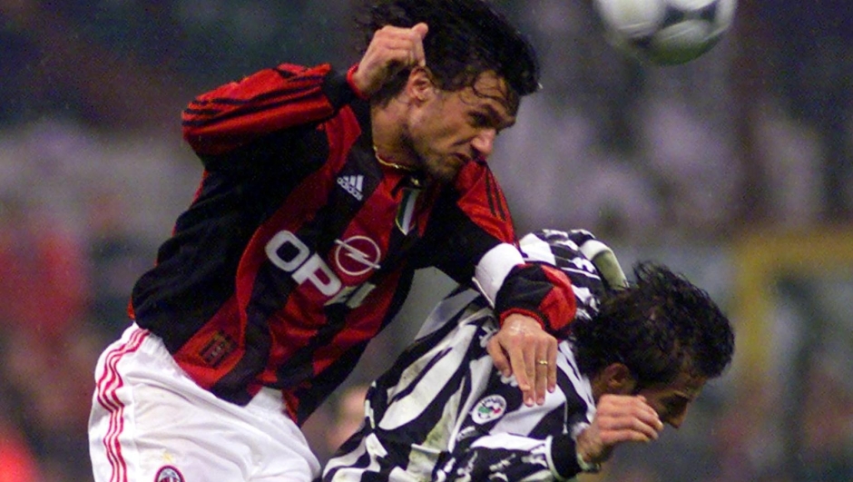 A.C. Milan's Paolo Maldini, left, jumps over Juventus of Turin's Alessandro Del Piero in their Italian major league match at the San Siro stadium in Milan, Italy, Friday, March 24, 2000. (AP Photo/Luca Bruno)