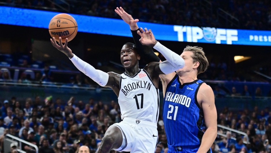 ORLANDO, FLORIDA - OCTOBER 25: Dennis Schroder #17 of the Brooklyn Nets draws a foul from Moritz Wagner #21 of the Orlando Magic in the first half of a game at Kia Center on October 25, 2024 in Orlando, Florida. NOTE TO USER: User expressly acknowledges and agrees that, by downloading and or using this photograph, User is consenting to the terms and conditions of the Getty Images License Agreement.   Julio Aguilar/Getty Images/AFP (Photo by Julio Aguilar / GETTY IMAGES NORTH AMERICA / Getty Images via AFP)