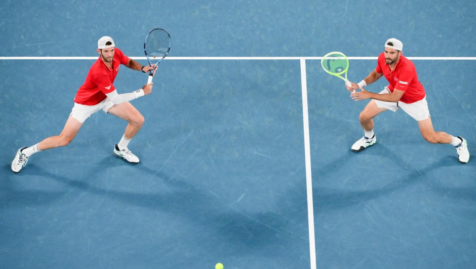 Italy's Andrea Vavassori (L) and Italy's Simone Bolelli play a point against Finland's Harri Heliovaara and Britain's Henry Patten during the men's doubles final match on day fourteen of the Australian Open tennis tournament in Melbourne on January 25, 2025. (Photo by Yuichi YAMAZAKI / AFP) / -- IMAGE RESTRICTED TO EDITORIAL USE - STRICTLY NO COMMERCIAL USE --
