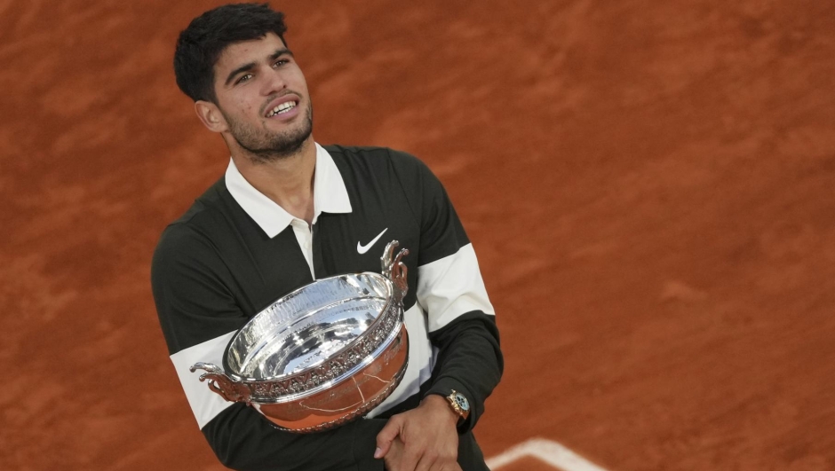 Spain's Carlos Alcaraz hold the trophy after winning the final match of the French Tennis Open at the Roland-Garros against Italy's Jannik Sinner in Paris, Sunday, June 8, 2025. (AP Photo/Aurelien Morissard)