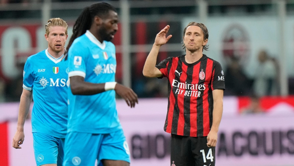 Napoli's Kevin De Bruyne, left, and Andre-Frank Zambo Anguissa walk as AC Milan's Luka Modric, right, reacts during the Serie A soccer match between AC Milan and Napoli at the San Siro stadium in Milan, Italy, Sunday, Sept. 28, 2025. (AP Photo/Luca Bruno)