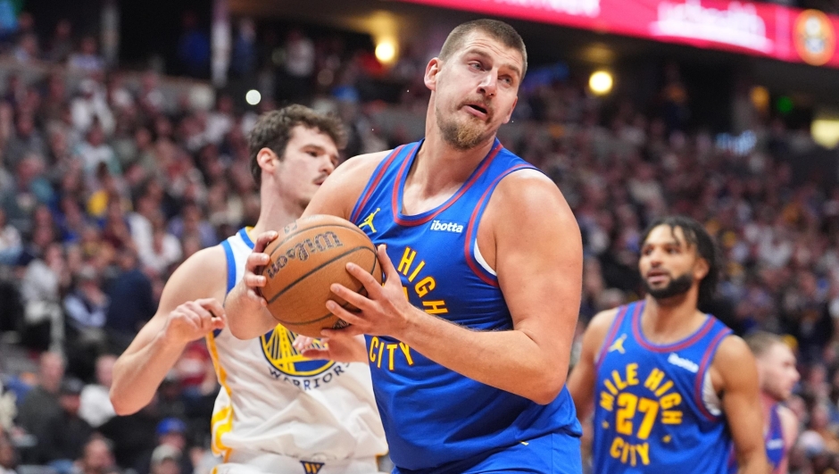 Denver Nuggets center Nikola JokiÄ&#135;, front, pulls in a rebound in front of guard Jamal Murray, back right, and Golden State Warriors center Quinten Post in the second half of an NBA Cup basketball game Friday, Nov. 7, 2025, in Denver. (AP Photo/David Zalubowski)