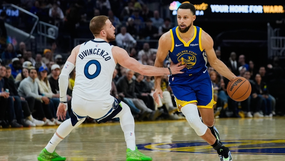 Golden State Warriors guard Stephen Curry (30) moves the ball while defended by Minnesota Timberwolves guard Donte Divincenzo (0) during the first half of an NBA basketball game, Friday, Dec. 12, 2025, in San Francisco. (AP Photo/Godofredo A. VÃ¡squez)