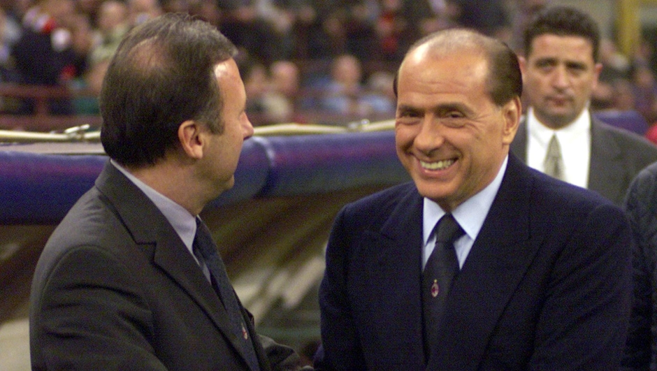 AC Milan president Silvio Berlusconi, right, shakes hands with coach Alberto FILE -- Zaccheroni prior to the Champions League, group H soccer match between Barcelona and AC Milan at the Milan San Siro stadium, Italy, Wednesday, October 18, 2000. A.C. Milan soccer club announced Wednesday, March 14, 2001, that Zaccheroni will be replaced by Cesare Maldini as coach of the team. (AP Photo/Luca Bruno)