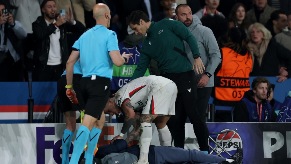 A ball kid lies on the floor after being pushed over by Pedro Neto of Chelsea (not pictured) as they are checked on by Enzo Fernandez of Chelsea during the UEFA Champions League 2025/26 Round of 16 First Leg match between Paris Saint-Germain FC and Chelsea FC at Parc des Princes on March 11, 2026 in Paris, France. (Photo by Justin Setterfield/Getty Images)