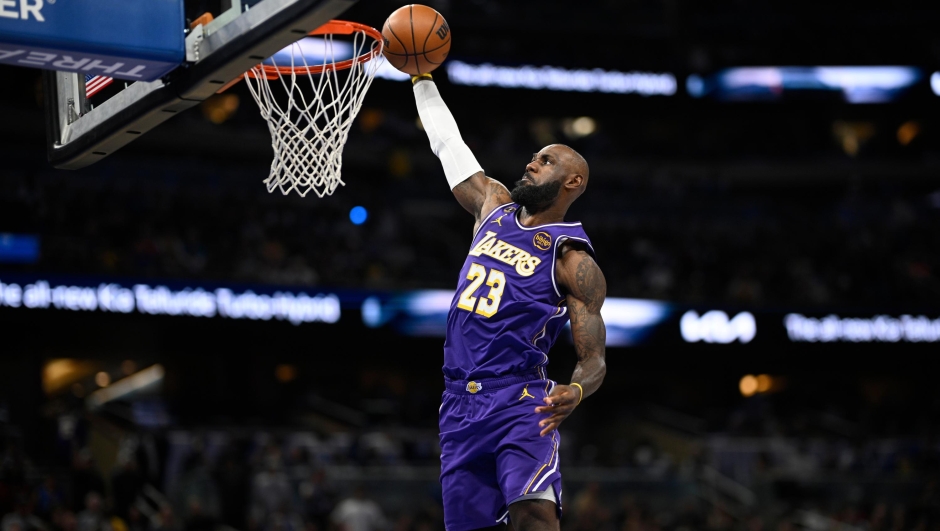 Los Angeles Lakers forward LeBron James (23) scores on a breakaway dunk during the first half of an NBA basketball game against the Orlando Magic, Saturday, March 21, 2026, in Orlando, Fla. (AP Photo/Phelan M. Ebenhack)