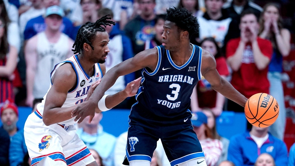  Forward AJ Dybantsa #3 of the BYU Cougars controls the ball as he is defended by guard Darryn Peterson #22 of the Kansas Jayhawks in the first half at Allen Fieldhouse on January 31, 2026 in Lawrence, Kansas.   Ed Zurga/Getty Images/AFP (Photo by Ed Zurga / GETTY IMAGES NORTH AMERICA / Getty Images via AFP)