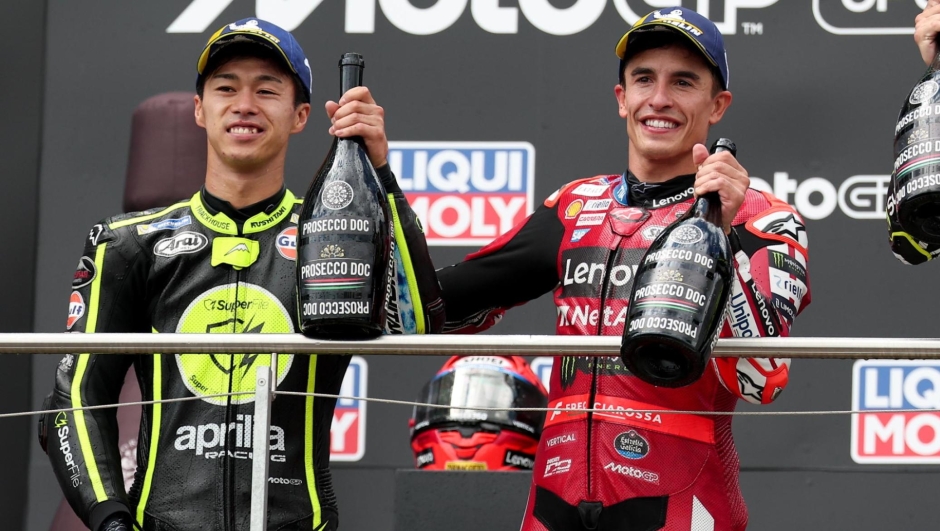 epa13106937 Winner, Ducati Lenovo Team rider Marc Marquez (C) of Spain celebrates on the podium with second placed Japanese MotoGP rider Ai Ogura (L)  of Trackhouse MotoGP and third placed Spanish MotoGP rider GP Raul Fernandez of Trackhouse Racing team after the Moto GP race of the motorcycling Grand Prix of Germany at the Sachsenring racing circuit in Hohenstein-Ernstthal, Germany, 12 July 2026.  EPA/FILIP SINGER