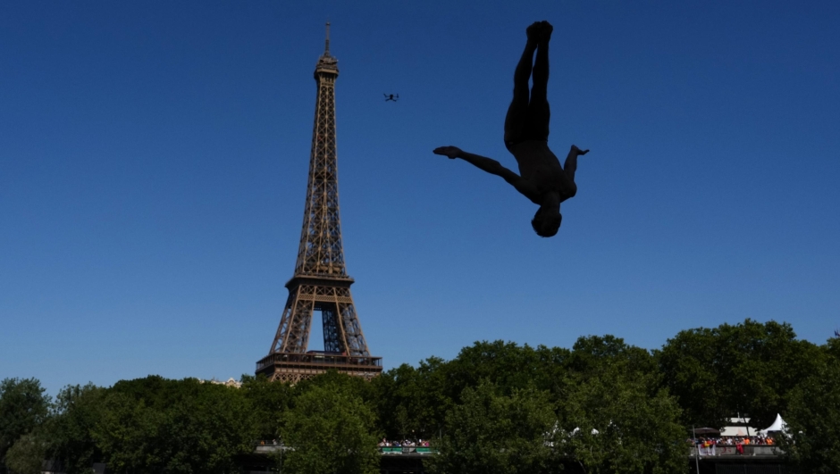 Italy's Andrea Barnaba competes in front of the Eiffel Tower during round 1 of the men's 20m Platform high diving at the European Aquatics Championships in Paris, Friday, Aug. 7, 2026. (AP Photo/Aurelien Morissard)