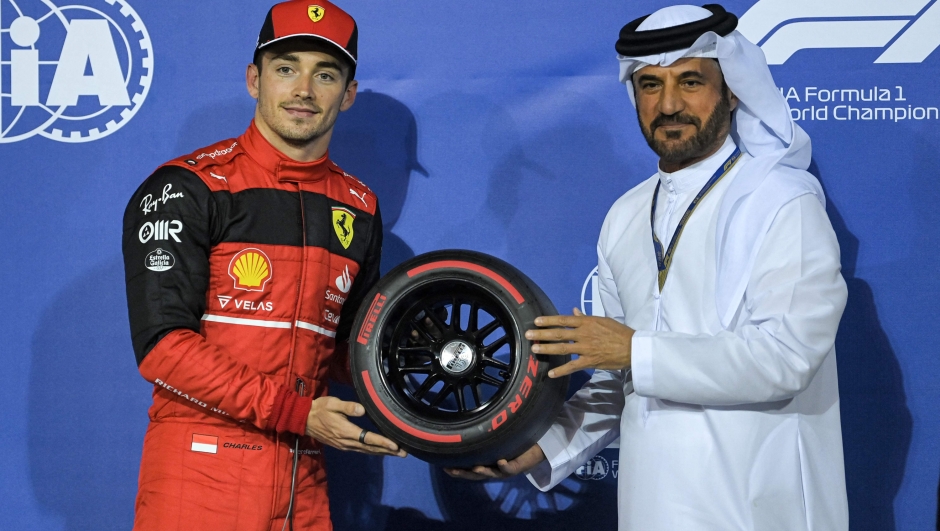 President of the International Automobile Federation (FIA) Mohammed Ben Sulayem (R) presents the Pole Position Award to Ferrari's Monegasque driver Charles Leclerc after the qualifying session on the eve of the Bahrain Formula One Grand Prix at the Bahrain International Circuit in the city of Sakhir on March 19, 2022. (Photo by OZAN KOSE / AFP)