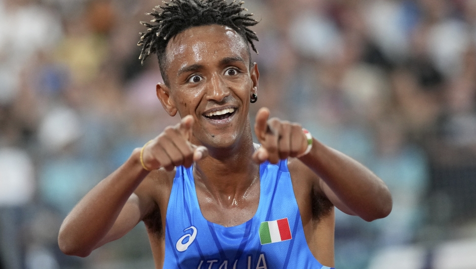 Yemaneberhan Crippa, of Italy, celebrates after winning the gold medal in the Men's 10,000 meters during the athletics competition in the Olympic Stadium at the European Championships in Munich, Germany, Sunday, Aug. 21, 2022. (AP Photo/Matthias Schrader)