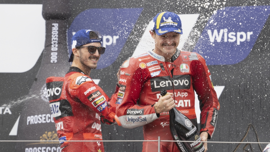 SPIELBERG, AUSTRIA - AUGUST 21: Francesco Bagnaia (L) of Italy and Ducati Lenovo Team and   Jack Miller of Australia and Ducati Lenovo Team celebrate on the podium during the MotoGP race during the MotoGP of Austria - Race at Red Bull Ring on August 21, 2022 in Spielberg, Austria. (Photo by Mirco Lazzari gp/Getty Images)