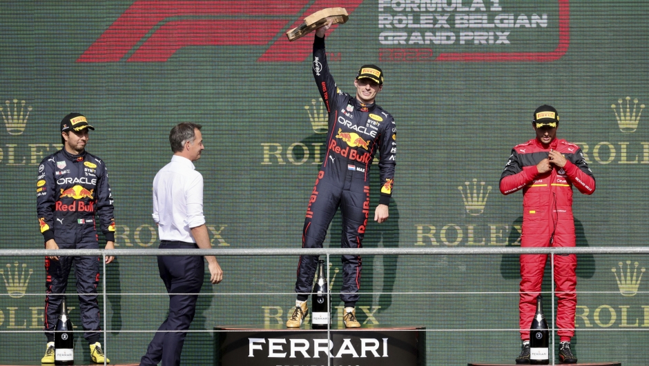 First place Red Bull driver Max Verstappen of the Netherlands, center, celebrates on the podium with second place Red Bull driver Sergio Perez of Mexico, left, and third place Ferrari driver Carlos Sainz of Spain during the Formula One Grand Prix at the Spa-Francorchamps racetrack in Spa, Belgium, Sunday, Aug. 28, 2022. (AP Photo/Olivier Matthys)