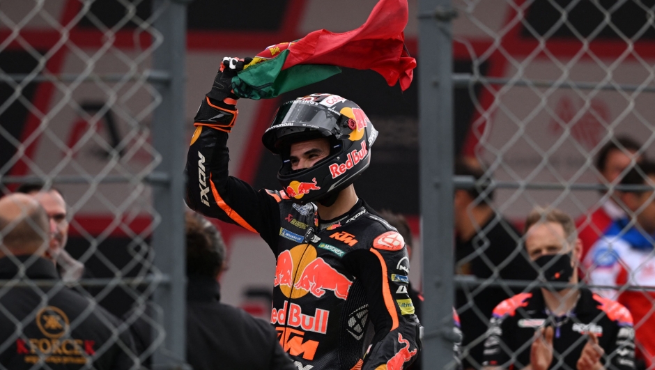 KTM Portuguese rider Miguel Oliveira waves a Portuguese flag after competing in the MotoGP Portuguese Grand Prix at the Algarve International Circuit in Portimao on April 24, 2022. (Photo by PATRICIA DE MELO MOREIRA / AFP)