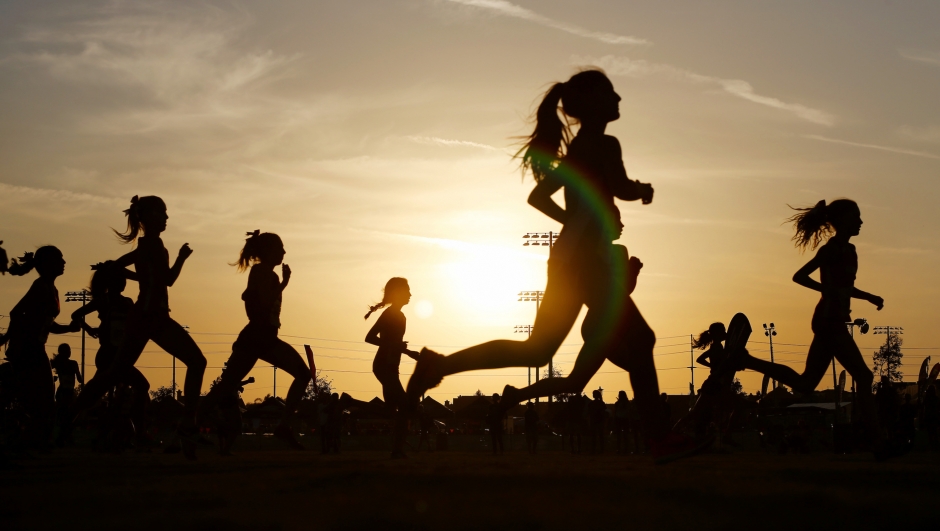 Runners compete in a 5k at sunset in Corona, California.