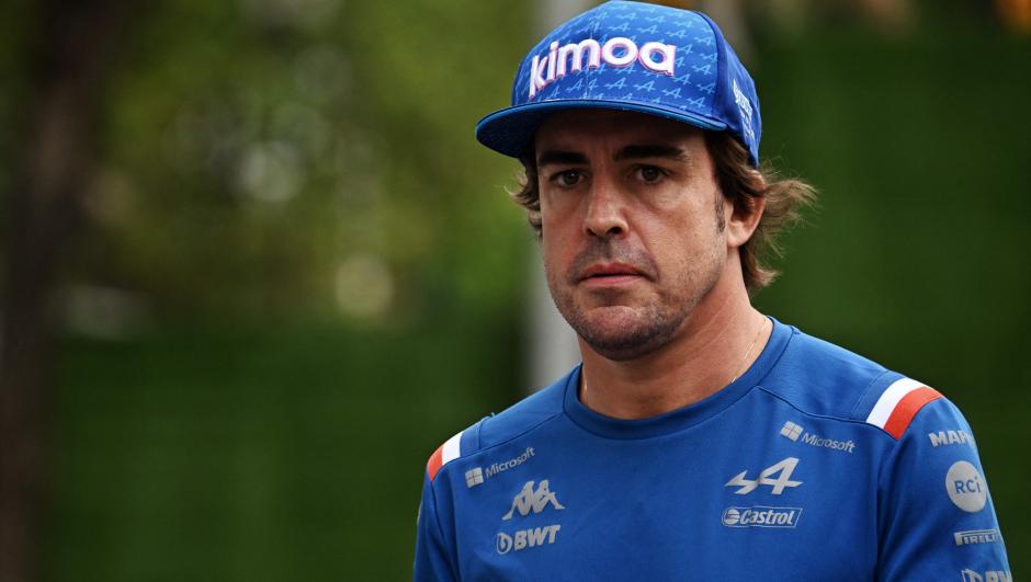Alpine's Spanish driver Fernando Alonso enters the paddock before the upcoming Formula One Singapore Grand Prix night race at the Marina Bay Street Circuit in Singapore on September 29, 2022. (Photo by Lillian SUWANRUMPHA / AFP)