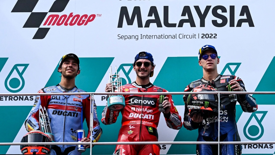 (from L-R) Second-placed Ducati Gresini Racing's Italian rider Enea Bastianini, winner Ducati Lenovo's Italian rider Francesco Bagnaia and third-placed Monster Energy Yamaha's French rider Fabio Quartararo celebrate during the podium ceremony after the MotoGP Malaysian Grand Prix motorcycle race at the Sepang International Circuit in Sepang on October 23, 2022. (Photo by MOHD RASFAN / AFP)