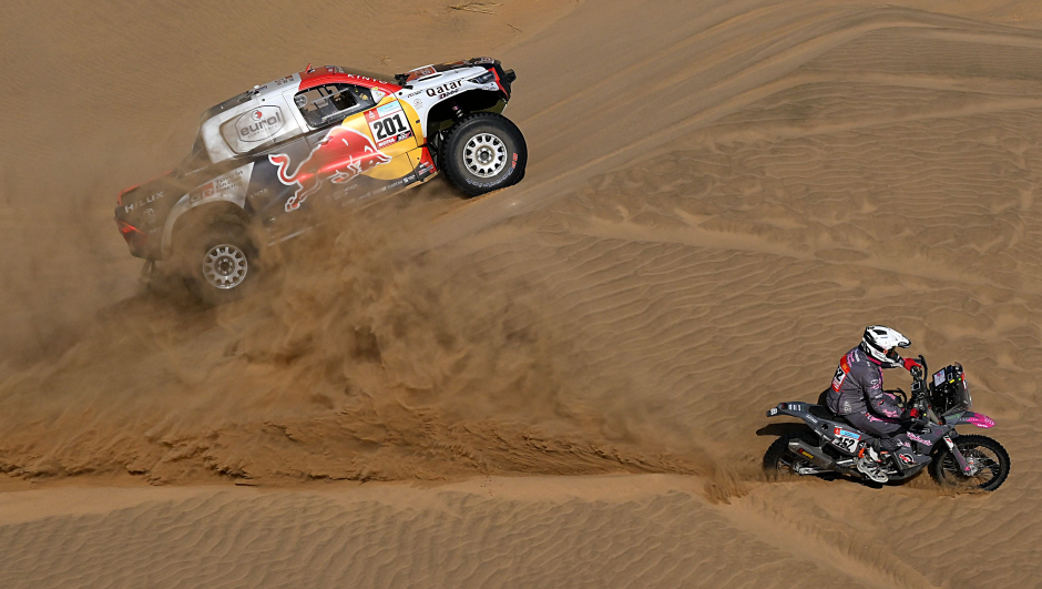 TOPSHOT - Toyota's driver Nasser Al-Attiyah of Qatar (R) and his co-driver Matthieu Baumel of France  compete during the Stage 11 of the Dakar 2022 around Bisha, Saudi Arabia, on January 13, 2022. (Photo by FRANCK FIFE / AFP)