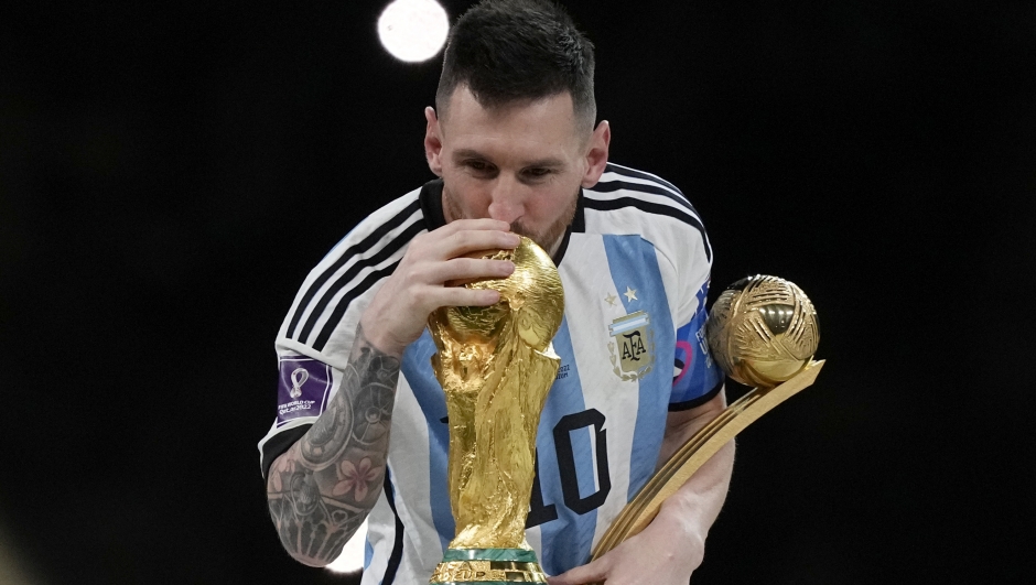Argentina's Lionel Messi kisses the trophy after winning the World Cup final soccer match between Argentina and France at the Lusail Stadium in Lusail, Qatar, Sunday, Dec. 18, 2022. Argentina won 4-2 in a penalty shootout after the match ended tied 3-3. (AP Photo/Martin Meissner)