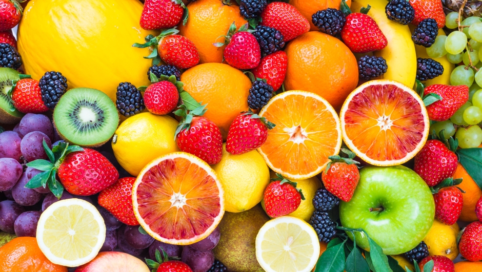 Fresh mixed fruits background.Organic fruits multicolore background.