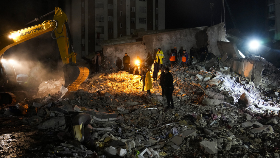 Emergency teams search through the rubble for people in a destroyed building in Adana, Turkey, Monday, Feb. 6, 2023. A powerful quake has knocked down multiple buildings in southeast Turkey and Syria and many casualties are feared. (AP Photo/Khalil Hamra)