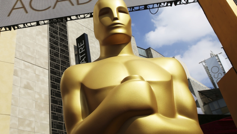 FILE - In this Feb. 21, 2015 file photo, an Oscar statue appears outside the Dolby Theatre for the 87th Academy Awards in Los Angeles. This year's Oscars will be held Sunday, March 12. The ceremony is set to begin at 8 p.m. EST and be broadcast live on ABC. Jimmy Kimmel will host for the third time and his first time since 2018.  (Photo by Matt Sayles/Invision/AP, File)