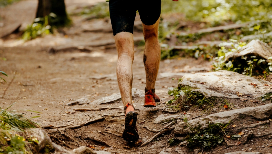 athlete runner dirty feet running forest trail