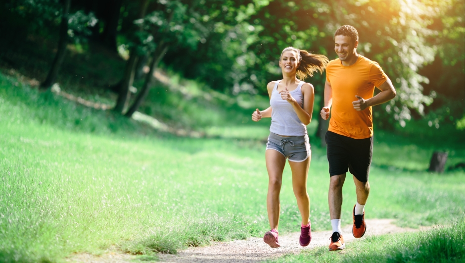 Healthy couple jogging in nature in good spirit