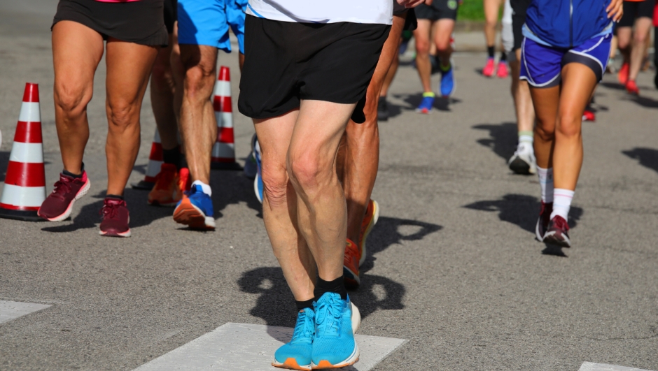 Athletic runners with muscular legs during the competitive run in the city