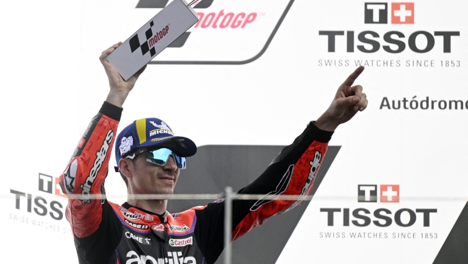 Second placed Aprilia Spanish rider Maverick Vinales celebrates on the podium of the MotoGP race of the Portuguese Grand Prix at the Algarve International Circuit in Portimao, on March 26, 2023. (Photo by PATRICIA DE MELO MOREIRA / AFP)