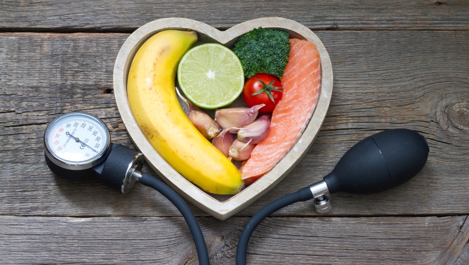 Health heart diet food concept with blood pressure gauge closeup