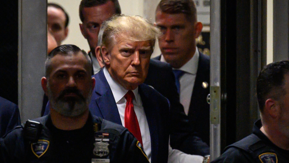 Former US President Donald Trump makes his way inside the Manhattan Criminal Courthouse in New York on April 4, 2023. - Donald Trump will make an unprecedented appearance before a New York judge on April 4, 2023 to answer criminal charges that threaten to throw the 2024 White House race into turmoil. (Photo by Ed JONES / AFP)