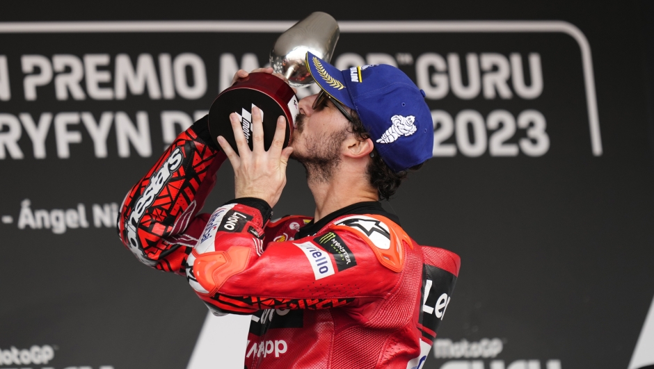 MotoGP rider Francesco Bagnaia of Italy celebrates on podium after winning the MotoGP race at the Circuito de Jerez in Jerez de la Frontera, Spain, Sunday, April 30, 2023. (AP Photo/Jose Breton)