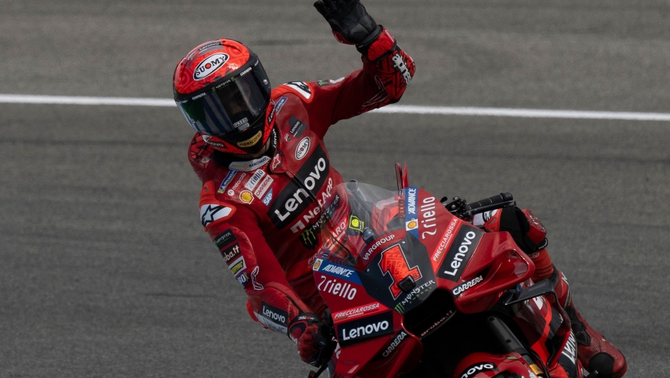 Ducati Italian rider Francesco Bagnaia waves to supporters rides during the qualifying session of the MotoGP Spanish Grand Prix at the Jerez racetrack in Jerez de la Frontera on April 29, 2023. (Photo by JORGE GUERRERO / AFP)
