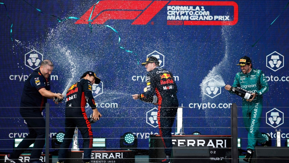 MIAMI, FLORIDA - MAY 07: Race winner Max Verstappen of the Netherlands and Oracle Red Bull Racing (second from right), Second placed Sergio Perez of Mexico and Oracle Red Bull Racing (second from left), Third placed Fernando Alonso of Spain and Aston Martin F1 Team (R) and Oliver Hughes, Chief Marketing Officer at Red Bull Racing (L) celebrate on the podium during the F1 Grand Prix of Miami at Miami International Autodrome on May 07, 2023 in Miami, Florida.   Jared C. Tilton/Getty Images/AFP (Photo by Jared C. Tilton / GETTY IMAGES NORTH AMERICA / Getty Images via AFP)