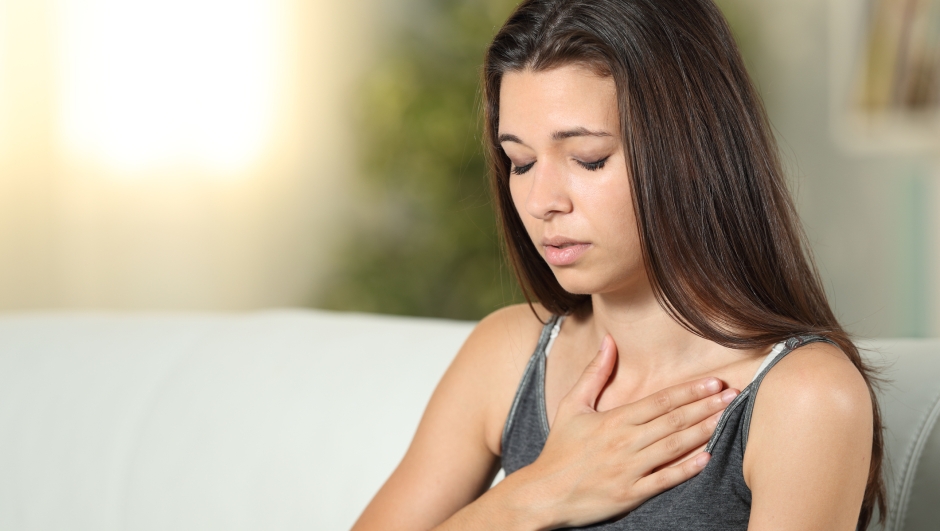 Girl having respiration problems touching chest