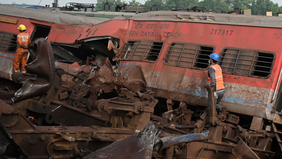 Rescue workers search for surviors amid the wreckage of carriages at the accident site of a three-train collision near Balasore, about 200 km (125 miles) from the state capital Bhubaneswar in the eastern state of Odisha, on June 3, 2023. At least 288 people were killed and more than 850 injured in a horrific three-train collision in India, officials said on June 3, the country's deadliest rail accident in more than 20 years. (Photo by DIBYANGSHU SARKAR / AFP)