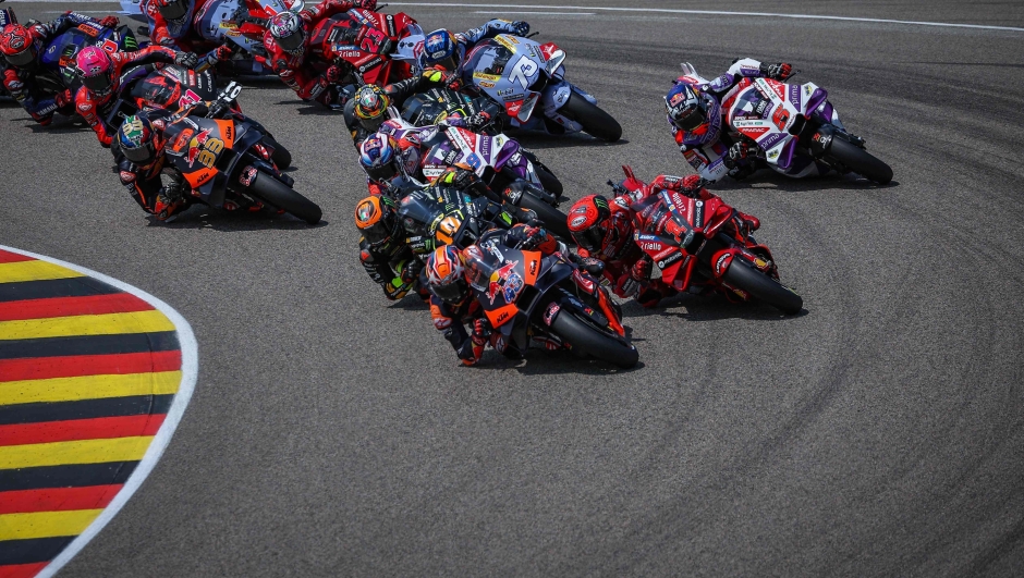 Riders compete in the MotoGP German motorcycle Grand Prix at the Sachsenring racing circuit in Hohenstein-Ernstthal near Chemnitz, eastern Germany, on June 18, 2023. (Photo by Ronny Hartmann / AFP)