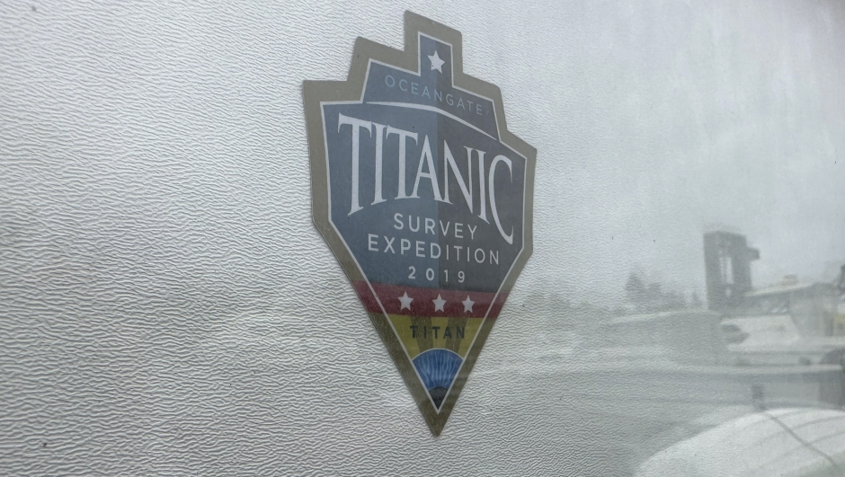 The logo for an OceanGate Expeditions 2019 Titanic expedition is seen on a marine industrial warehouse office door in Everett, Wash., Tuesday, June 20, 2023. Rescuers are racing against time to find the missing submersible carrying five people, who were reported overdue Sunday night. (AP Photo/Ed Komenda)