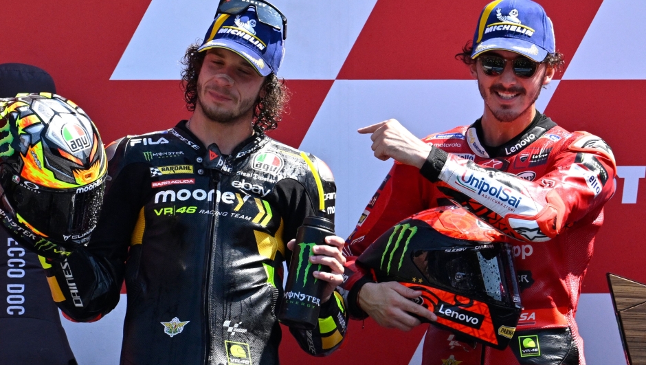 First-placed Ducati Lenovo Team's Italian rider Francesco Bagnaia and second-placed Mooney VR46 Racing's Italian rider Marco Bezzecchi (L) celebrate on the podium after the Dutch MotoGP at the TT circuit of Assen, on June 25, 2023. (Photo by John THYS / AFP)